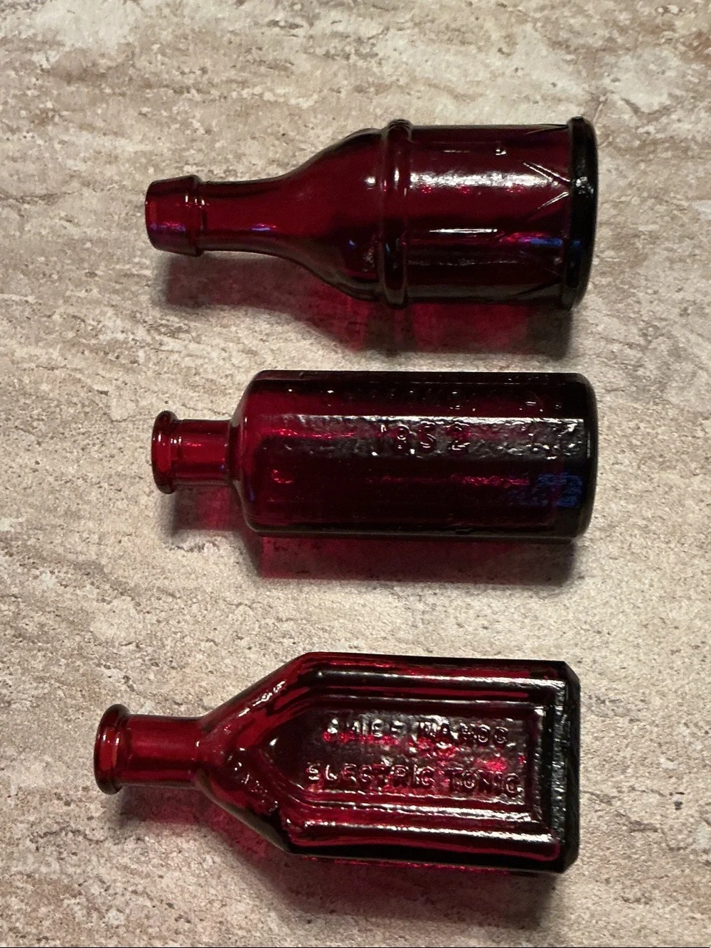 Set of 3 vintage Wheaton celebrated remedy ruby red bitters bottles.